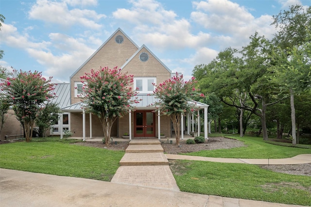 view of front of property with a front yard and french doors