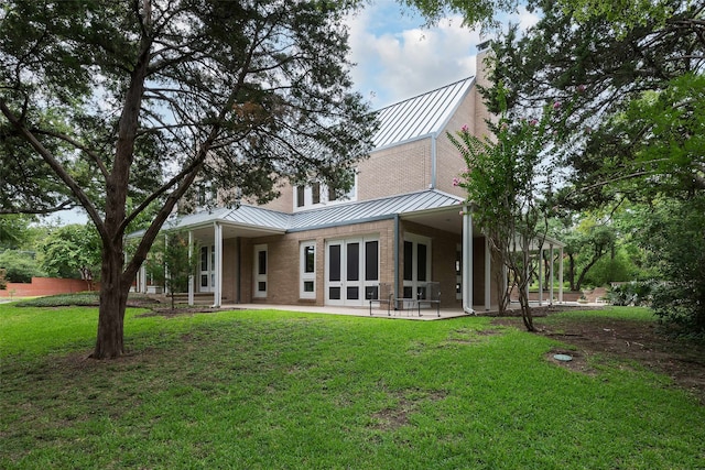 back of house with a yard and a patio area