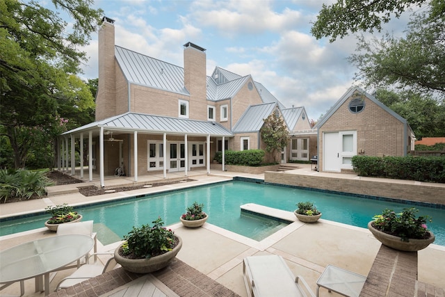 view of pool with a patio and french doors