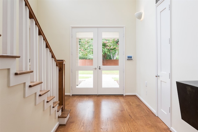 entryway featuring light wood-type flooring, french doors, and a wealth of natural light