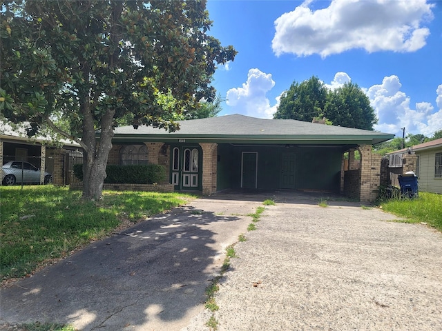 single story home with brick siding and driveway