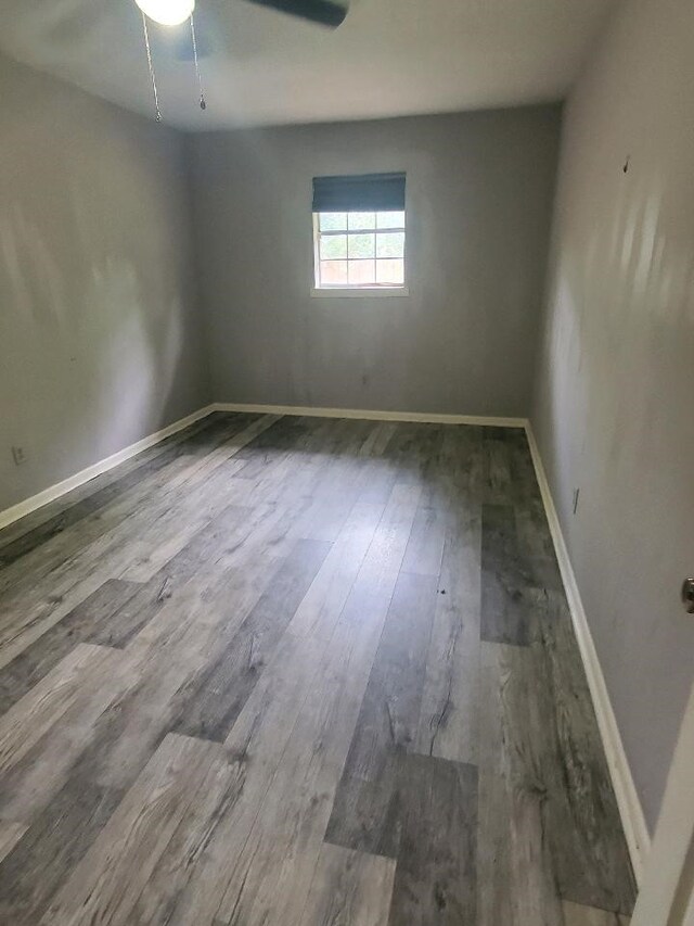 empty room with baseboards and wood finished floors