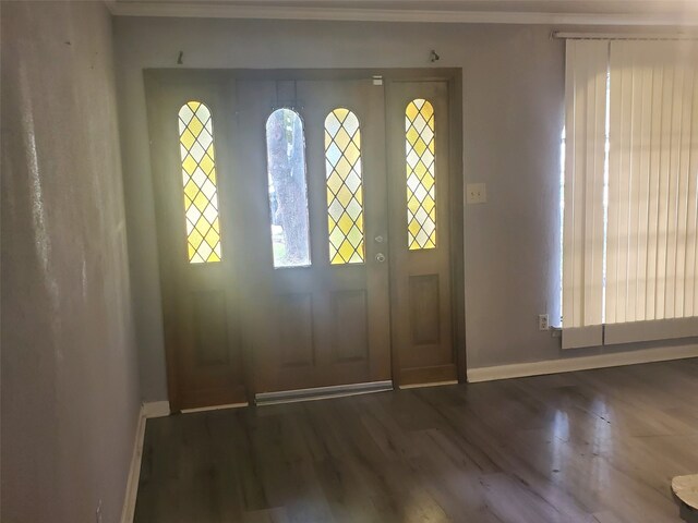 entryway with crown molding, baseboards, and wood finished floors