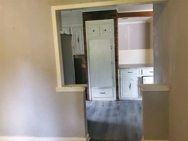 kitchen with white cabinets, light countertops, and dark wood-type flooring