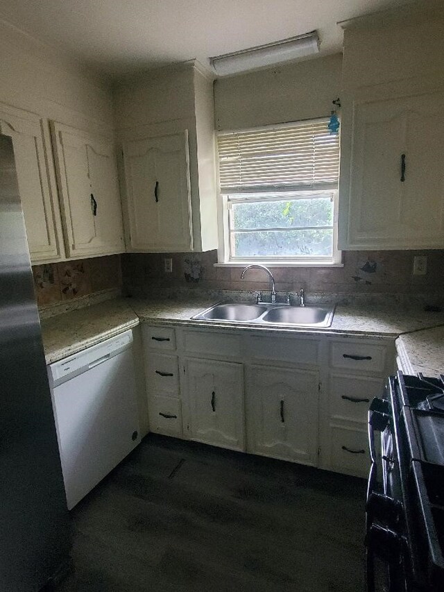 kitchen with a sink, range with gas stovetop, tasteful backsplash, white cabinets, and dishwasher