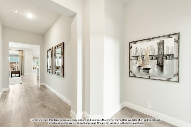 hallway with light hardwood / wood-style floors