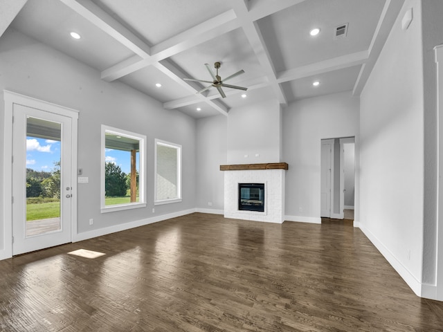 unfurnished living room featuring beam ceiling, ceiling fan, dark hardwood / wood-style floors, and coffered ceiling