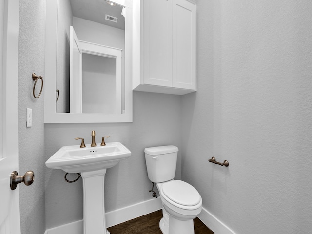 bathroom with sink, wood-type flooring, and toilet