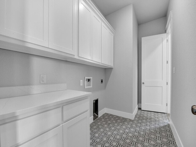 washroom with washer hookup, electric dryer hookup, cabinets, and light tile patterned floors