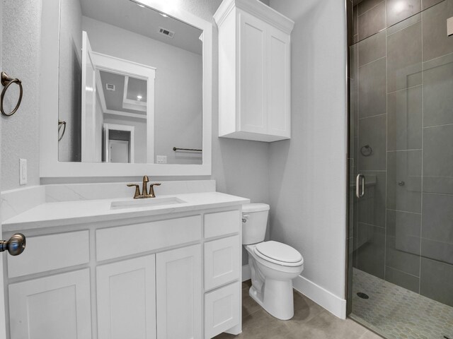 bathroom with vanity, toilet, and a shower with shower door