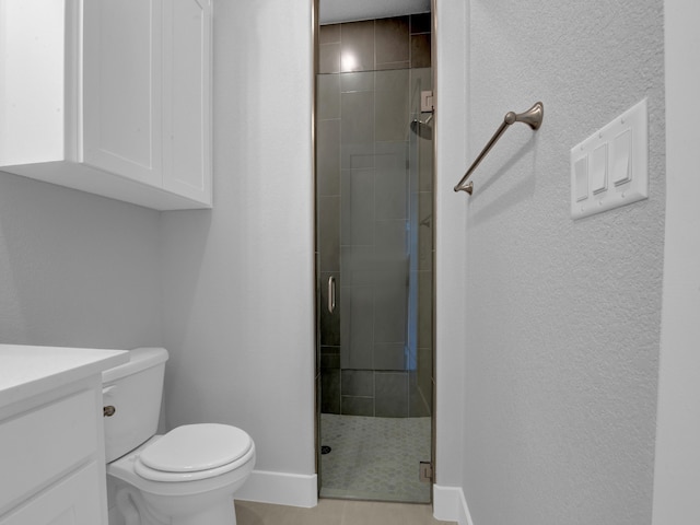 bathroom featuring walk in shower, tile patterned flooring, vanity, and toilet