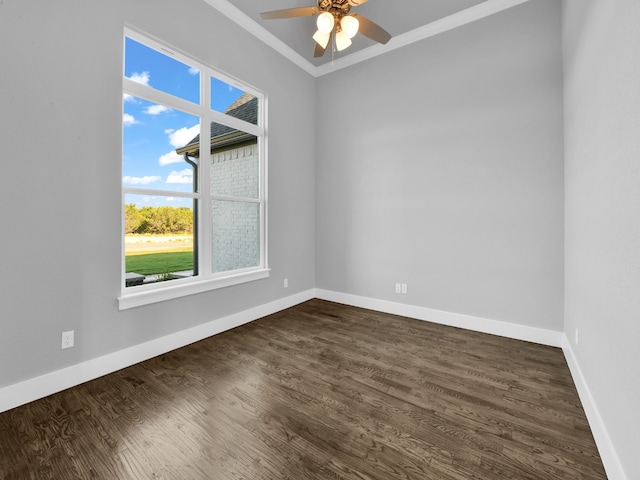 empty room featuring dark hardwood / wood-style flooring, ceiling fan, and ornamental molding