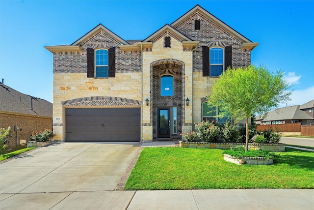 french country home featuring driveway, a garage, stone siding, a front lawn, and brick siding