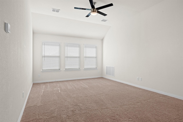 unfurnished room with a ceiling fan, light colored carpet, and visible vents