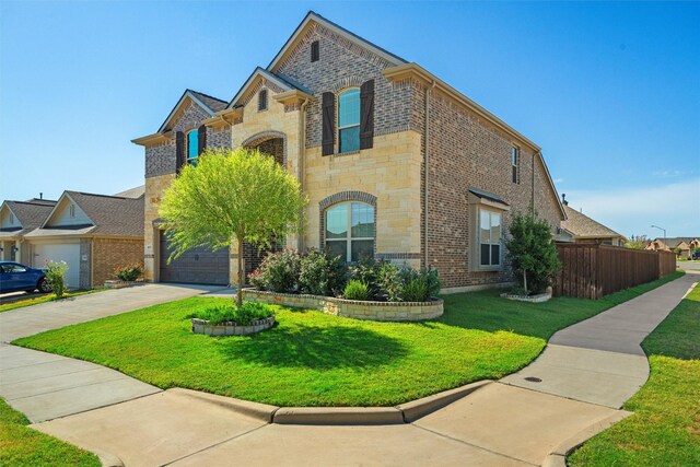 view of front of house with a garage and a front lawn