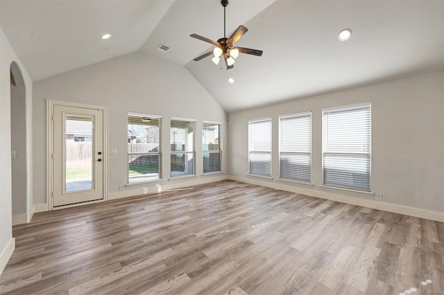 unfurnished living room with ceiling fan, plenty of natural light, and light wood-type flooring