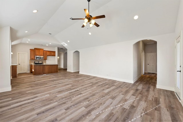 unfurnished living room featuring ceiling fan, light hardwood / wood-style flooring, and high vaulted ceiling