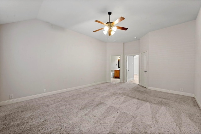 carpeted spare room with ceiling fan and lofted ceiling