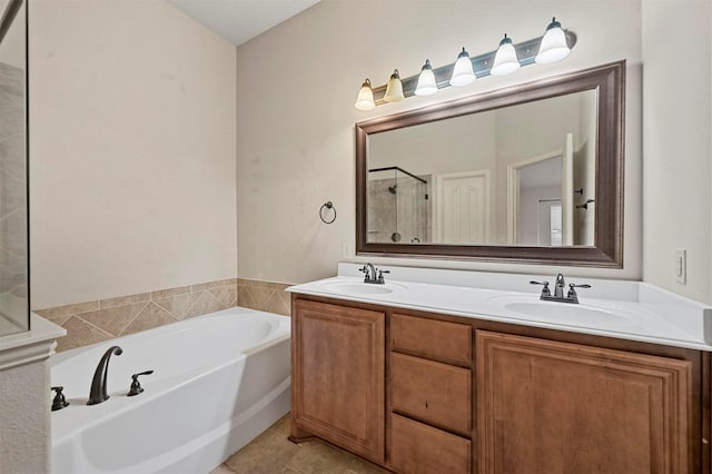 bathroom with plus walk in shower, vanity, and tile patterned flooring