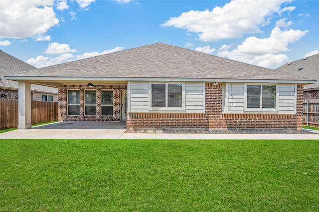 rear view of property featuring a yard and a patio