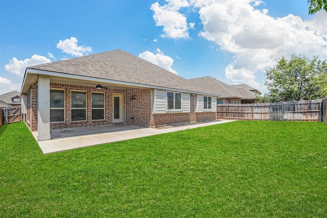 back of house featuring ceiling fan, a patio area, and a yard