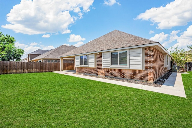 rear view of property featuring a lawn