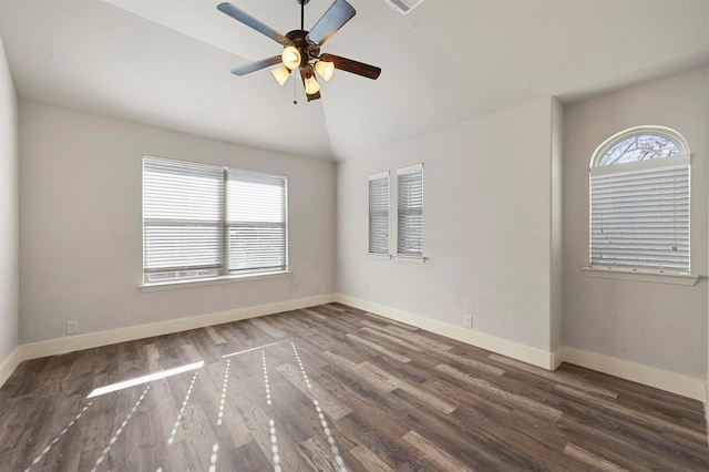 unfurnished room featuring ceiling fan, vaulted ceiling, and dark wood-type flooring