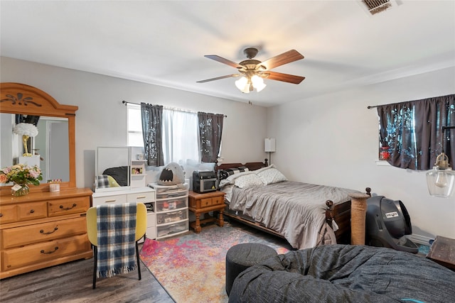 bedroom with ceiling fan and hardwood / wood-style flooring