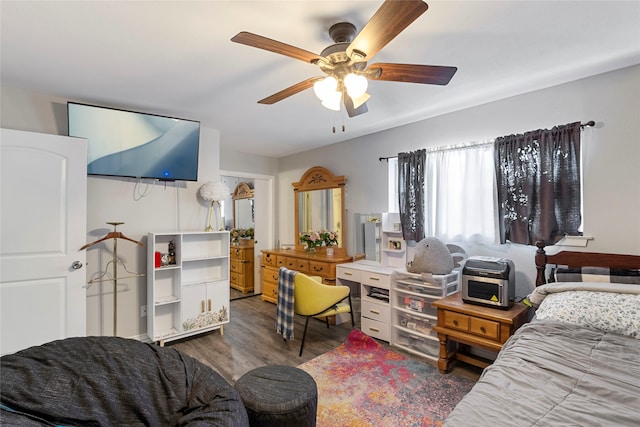 bedroom with ceiling fan and dark wood-type flooring