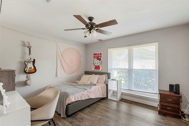 bedroom with dark hardwood / wood-style floors and ceiling fan