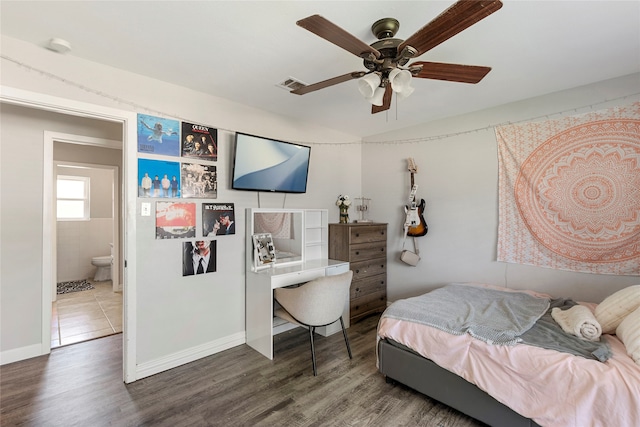 bedroom featuring ensuite bath, wood-type flooring, and ceiling fan