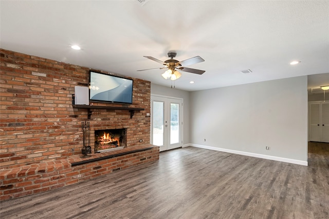 unfurnished living room featuring brick wall, ceiling fan, french doors, and dark wood-type flooring