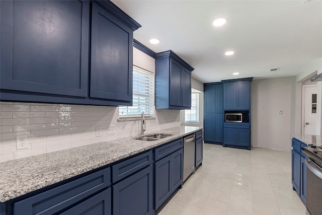 kitchen featuring tasteful backsplash, stainless steel appliances, sink, light stone counters, and light tile patterned floors