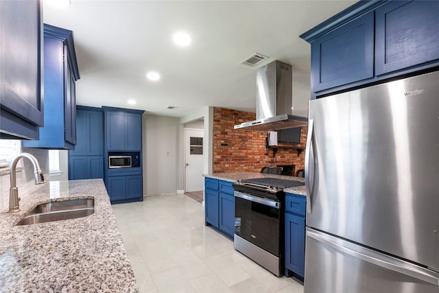 kitchen featuring sink, appliances with stainless steel finishes, light stone counters, and island range hood