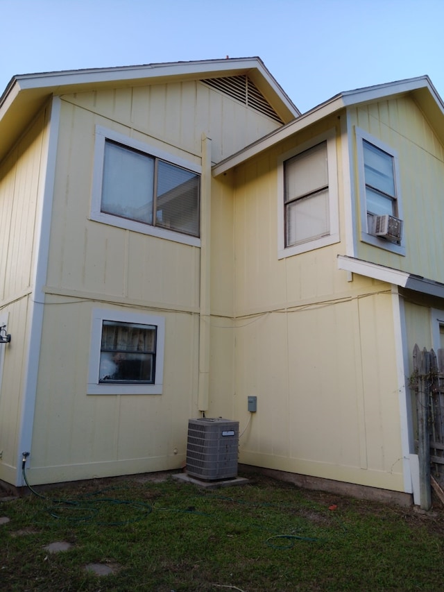 rear view of property featuring cooling unit and central AC