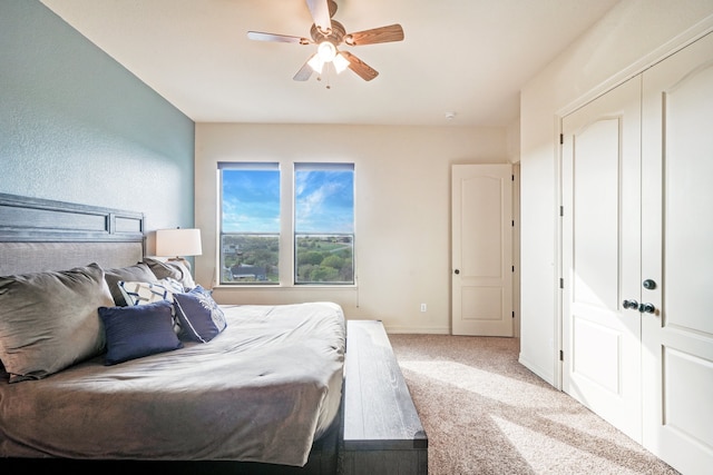 bedroom with ceiling fan, a closet, and carpet flooring