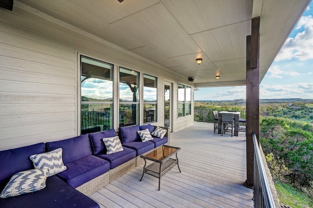 wooden terrace featuring an outdoor living space