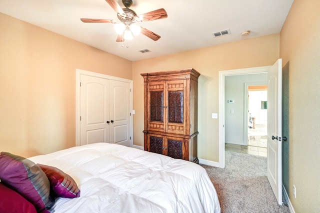 bedroom with carpet floors, baseboards, visible vents, and a ceiling fan