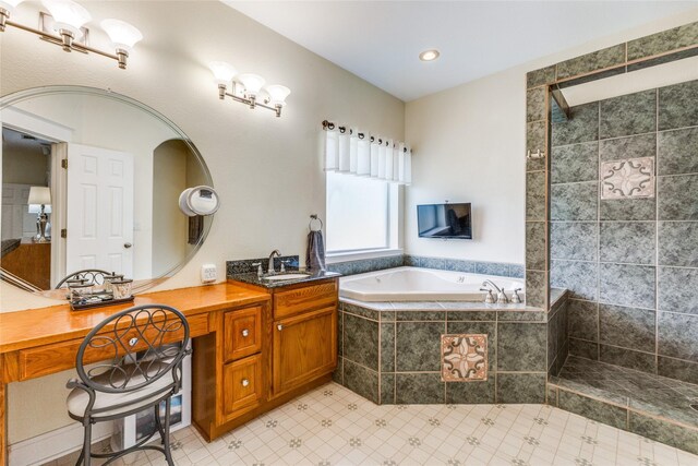 bathroom with vanity and shower with separate bathtub