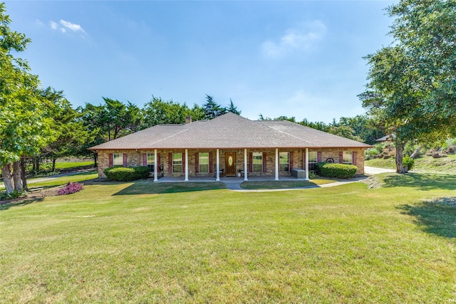 back of property with a yard and covered porch