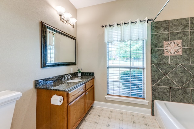 bathroom featuring shower / bathing tub combination, vanity, and plenty of natural light