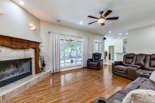 living room featuring hardwood / wood-style floors and a tiled fireplace