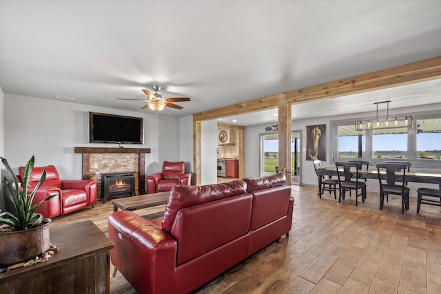 1320 Murrah Ln, Kaufman, TX 75142 - living area featuring a stone fireplace, ceiling fan, and wood finished floors
