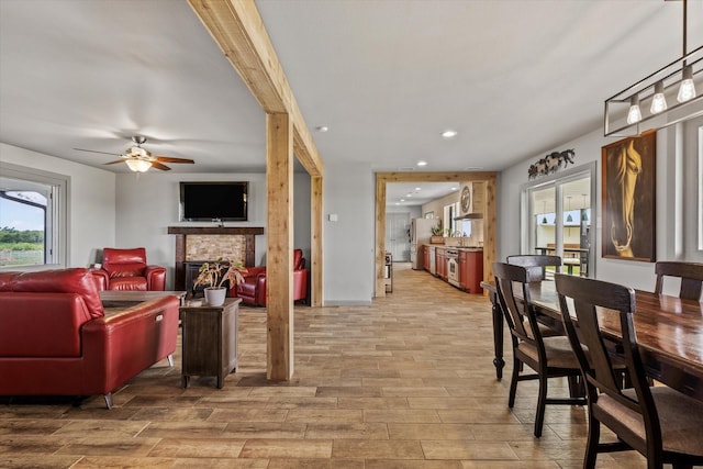 1320 Murrah Ln, Kaufman, TX 75142 - living area featuring wood finished floors, ceiling fan, a fireplace, and recessed lighting