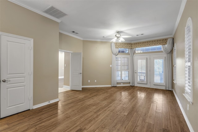 spare room with ornamental molding, hardwood / wood-style floors, and ceiling fan