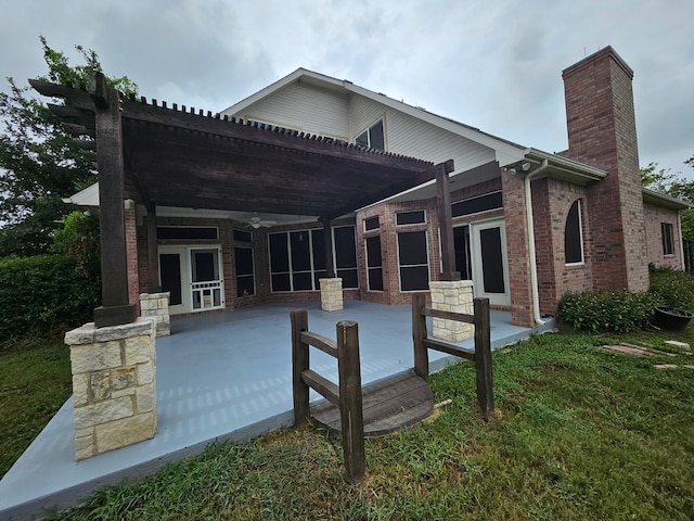 rear view of property with a pergola, a yard, and a patio area