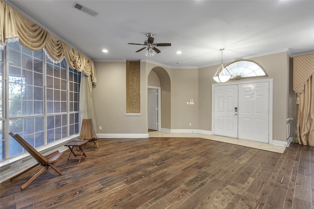 foyer with crown molding, ceiling fan, and hardwood / wood-style flooring