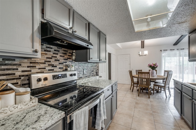 kitchen with decorative light fixtures, tasteful backsplash, an inviting chandelier, stainless steel electric range oven, and a textured ceiling