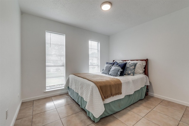 tiled bedroom with a textured ceiling