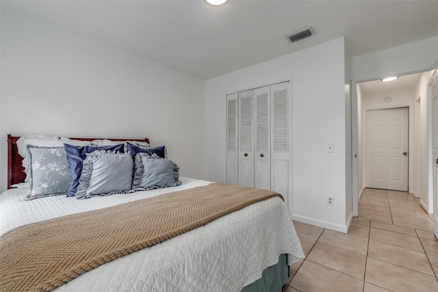 tiled bedroom featuring a closet